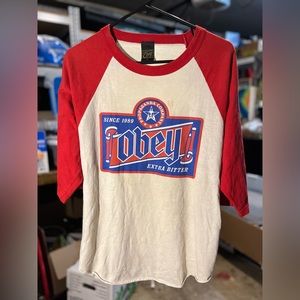 Vintage cream and red colored proganda obey